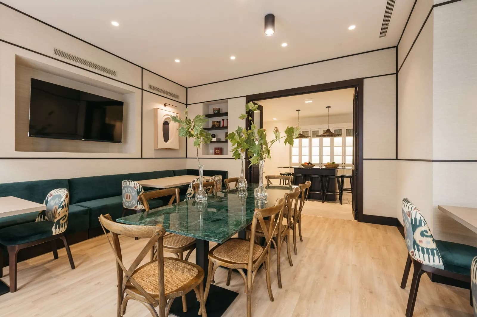 Vista panorámica de la sala con jarrones y puerta a la cocina